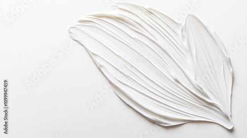 Delicate white petal-like structure with intricate veins and ridges, sculpted in plaster or clay, set against a pristine white background. Minimalist art piece. photo