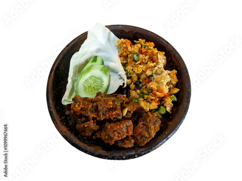 Paru Balado with spicy vegetable salad, and sliced cucumber on a cobek or plate made from clay. This is an traditional Indonesian menu for lunch or breakfast. photo