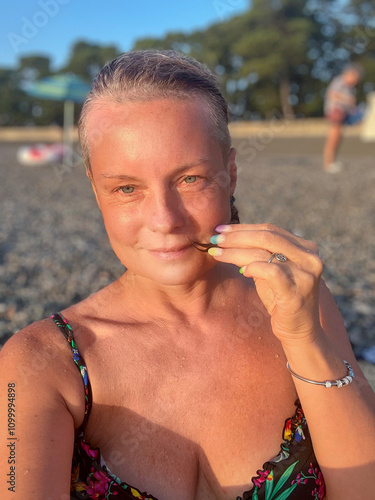 woman in a swimsuit on the background of a pebble beach in Kobuleti, Georgia photo