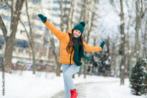 Portrait of attractive cheerful funky carefree girly girl wearing warm clothes dancing having fun snowy weather outdoors photo