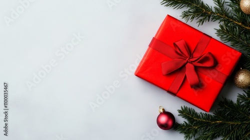 Festive Christmas gift, red ribbon, pink and gold ornaments on light background; holiday atmosphere Red, pink, gold 