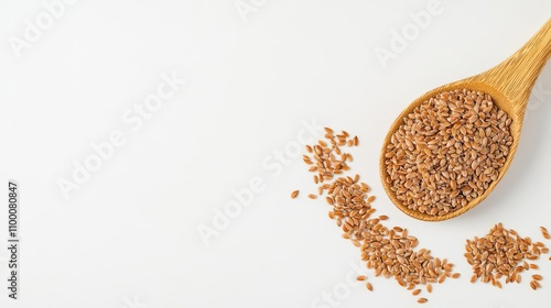 A wooden spoon filled with golden flaxseeds, surrounded by scattered seeds on a clean white background. Perfect for nutrition and healthy cooking.