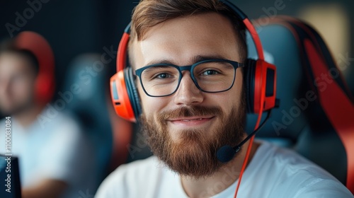 A joyful individual with a bright smile seated and wearing a headset, engaged in a lighthearted gaming session, showcasing happiness and enthusiasm. photo