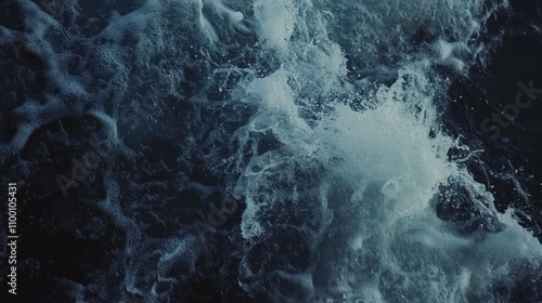 A close-up view of turbulent ocean waves creating splashes and foam.