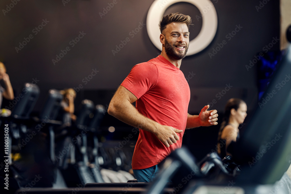 © Dusan Petkovic - Happy sportsman running on treadmill at gym and smiling at camera. © Dusan Petkovic - Happy sportsman running on treadmill at gym and smiling at camera.