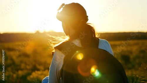Horizontal video footage, girl woman with a backpack walking in a field at sunset or sunrise, hiking, camping, travel