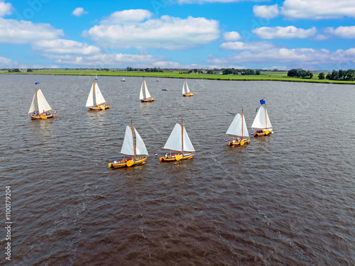 Aerial from admiral sailing with ancient wooden ships on the Heegermeer in Friesland the Netherlands photo