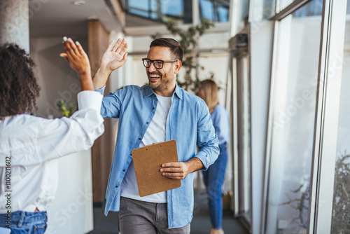 Two Colleagues Sharing a Successful High Five at Work