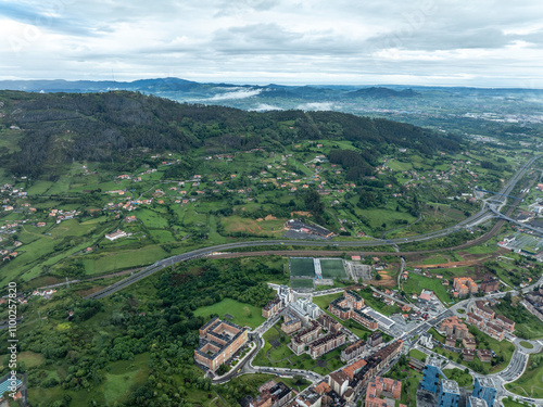 Aerial view of a beautiful small town surrounded by greenery and mountains, Oviedo City, Spain. photo