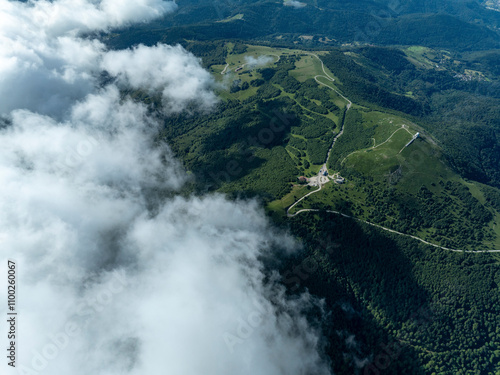 Aerial view of serene and majestic mountains surrounded by lush forests and expansive valleys under a tranquil sky, Lautenbachzell, France. photo