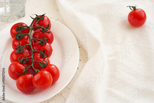 red cherry tomatoes lie in a plate on the table