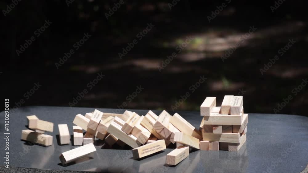 Jenga tower collapses in slow motion capturing the suspense and thrill of the game