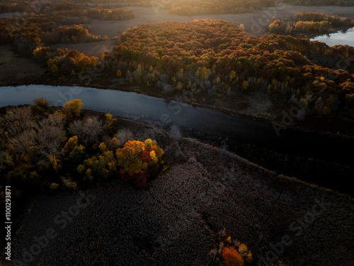 Aerial view of breathtaking autumn foliage and tranquil river surrounded by serene forest, West Roxbury, Massachusetts, United States. photo