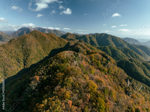 Aerial view of the serene and majestic Mount Picentini in autumn foliage surrounded by rugged mountains and forest, Giffoni Valle Piana, Italy. photo