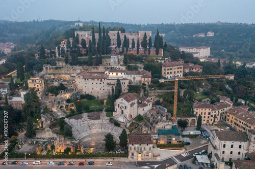 Aerial view of the historic roman theatre and Castel San Pietro surrounded by beautiful cypress trees, Verona, Italy. photo