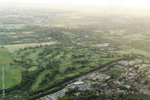 Aerial view of lush greenery and fields with residential buildings and a golf course, Monti, Rome, Italy. photo