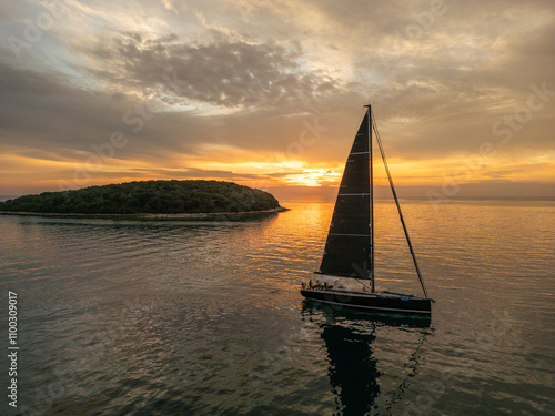 Aerial view of a beautiful sailing boat on calm sea at sunset, Funtana, Croatia. photo