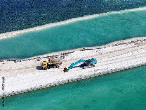 Aerial view of the construction site with excavator and truck on an artificial island in the lagoon, Hithadhoo, Maldives. photo