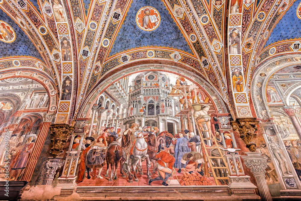 Obraz premium Siena, Italy - June 22, 2024: Siena: Santa Maria della Scala Hospital. Fresco by Domenico di Bartolo: Construction of the foundations of the walls of the hospital (1443).