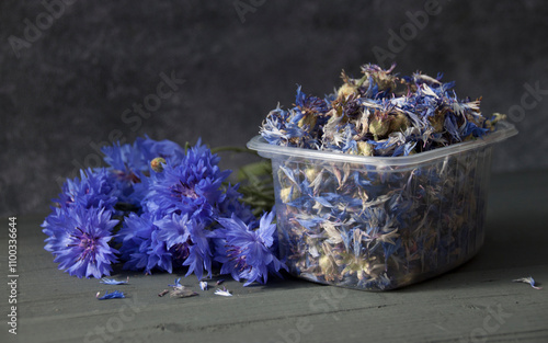 Dry cornflower flowers in a plastic container