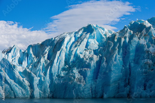 View of majestic glacier and icy mountains under a beautiful sky with clouds, Torres del Paine National Park, Chile. photo