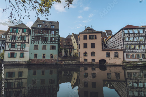 View of picturesque canal with charming timber-framed buildings and serene water reflections, Strasbourg, France. photo