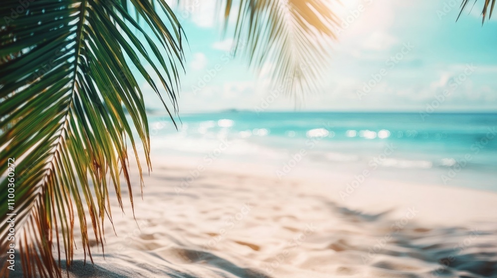 Fototapeta premium A tropical beach scene with soft white sand and a turquoise ocean, blurred palm trees in the distance,