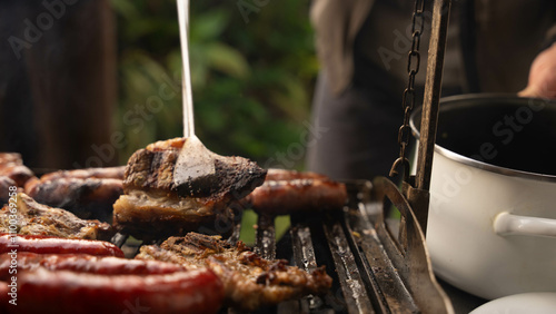 pieces of meat of various kinds are grilled on a grill where care must be taken so that they are neither overcooked nor undercooked photo