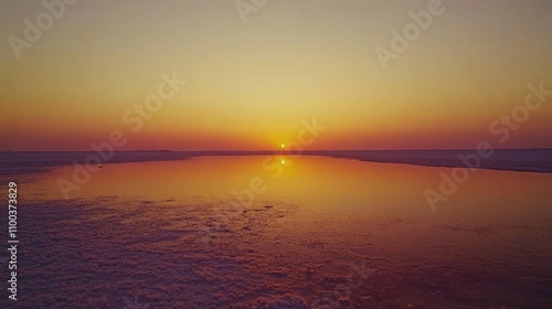 A tranquil shot of the Rann of Kutch during sunrise, with the sky painted in hues of orange and pink, reflecting on the salt flats, photo