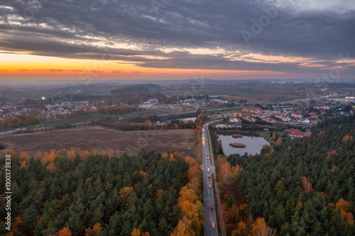 Beautiful sunset over the autumnal forest in Rotmanka, Poland photo