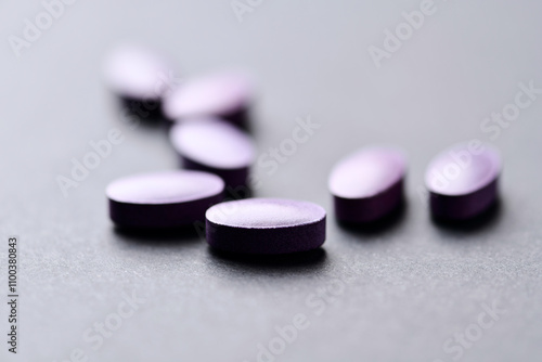 Lutein tablets. Dietary supplement on paper background. Soft focus. Close up. Copy space photo