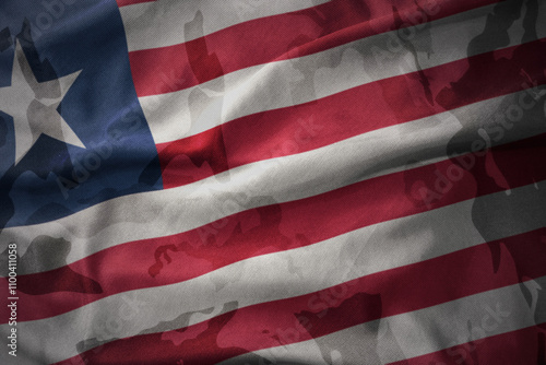 colourful waving flag of liberia on the old army khaki texture background. military concept. photo