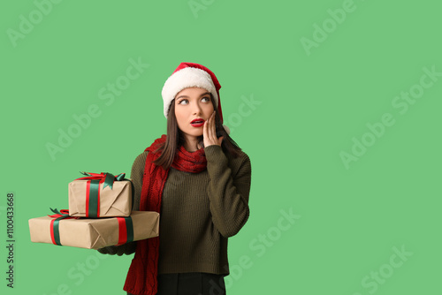 Young woman in Santa hat wi...