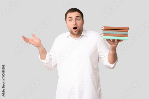 Shocked young man with book...