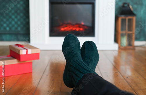 woman wearing wool socks in front of fireplace