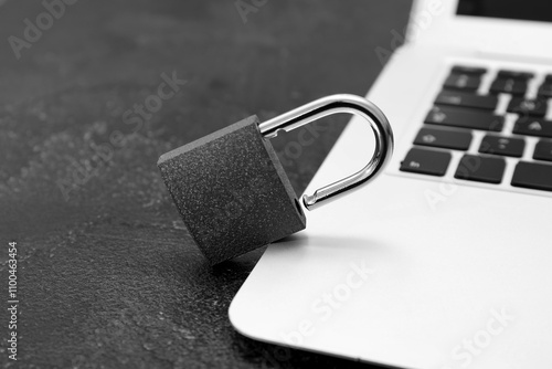 Padlock with laptop on dark...
