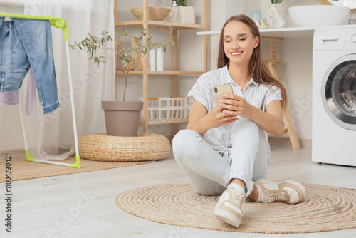 Young woman using mobile ph...