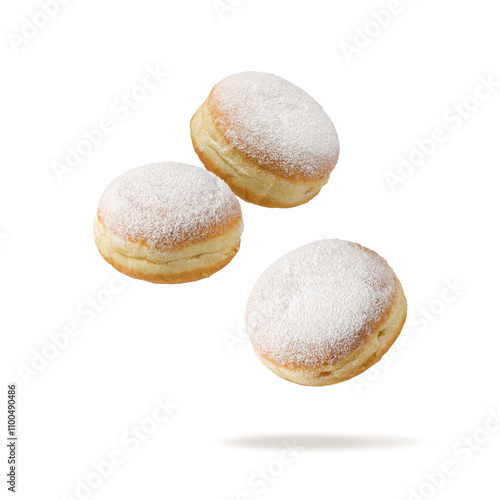 Three fresh baked donuts Berliner icing sugar powder flying isolated on white background.