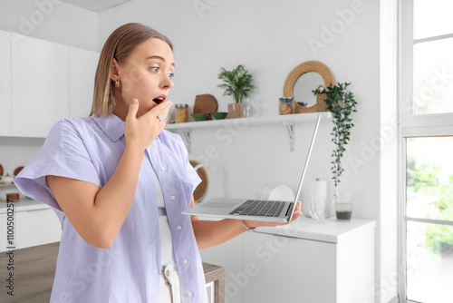 Shocked young woman with la...