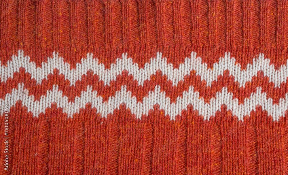 Fototapeta premium Red Knitted Christmas Sweater with Zigzag Pattern Background