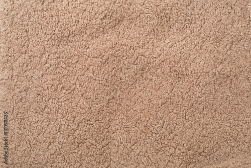 Brown cuddle teddy bear fabric as background, top view