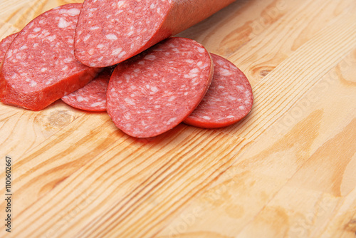 Obraz na płótnie Sausage stick on wooden background. Pork beef sausage. w salonie