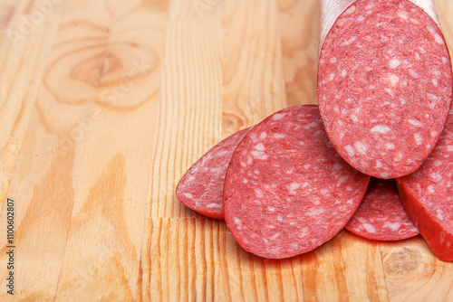 Obraz na płótnie Sausage stick on wooden background. Pork beef sausage. w salonie
