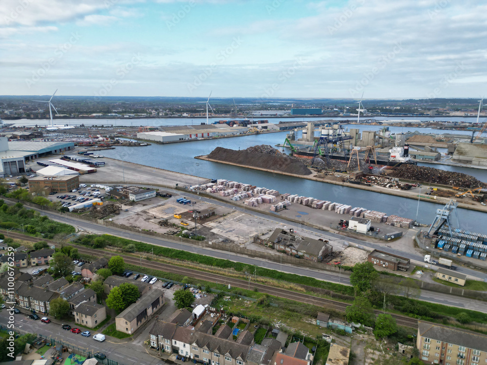 Fototapeta premium High Angle View of Tilbury City Centre and Docks on River Thames, borough of Thurrock, Essex, England, United Kingdom. Aerial View Was Captured with Drone's Camera on April 20th, 2024 at Just After Su