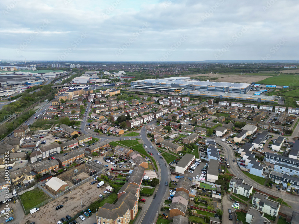 Fototapeta premium High Angle View of Tilbury City Centre and Docks on River Thames, borough of Thurrock, Essex, England, United Kingdom. Aerial View Was Captured with Drone's Camera on April 20th, 2024 at Just After Su