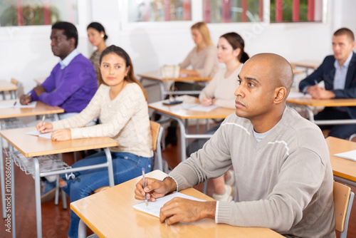 Portrait of a student at a desk in a university audience photo