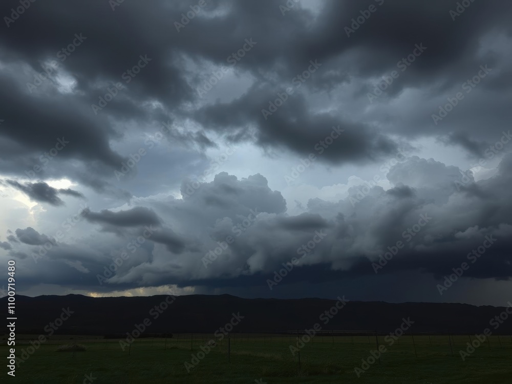 Fototapeta premium Dramatic storm clouds gathering over a dark and moody landscape, nature, weather