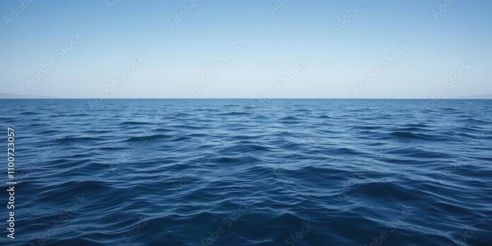 Obraz premium A serene ocean background with gentle waves and a clear blue sky, natural, calm