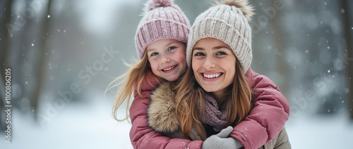 Two girls hug and smile in the snow. photo