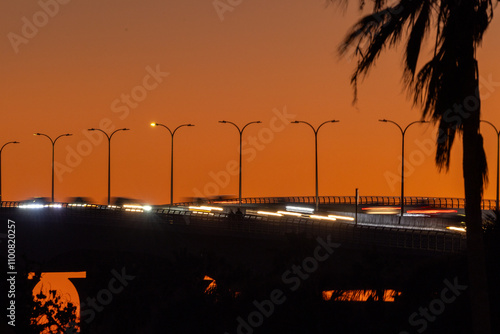 Long exposure of traffic driving over the Ringling Causeway in Sarasota, Florida, during sunset photo